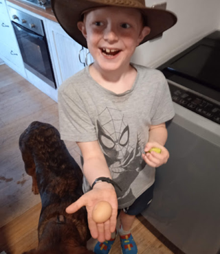 Caleb with first egg